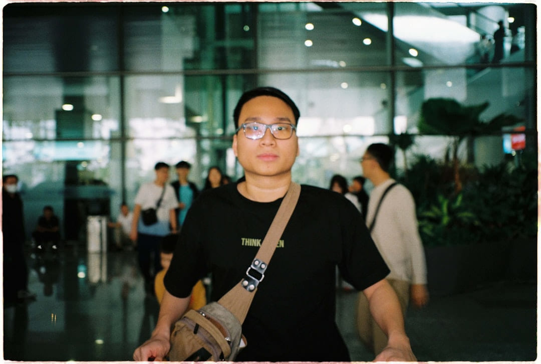 Man in black shirt with glasses and bag on Miles and Memories