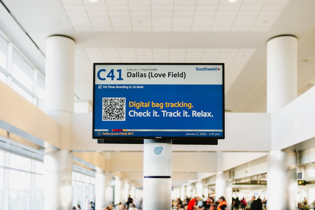 Airport sign showing flight information and bag tracking on Miles and Memories