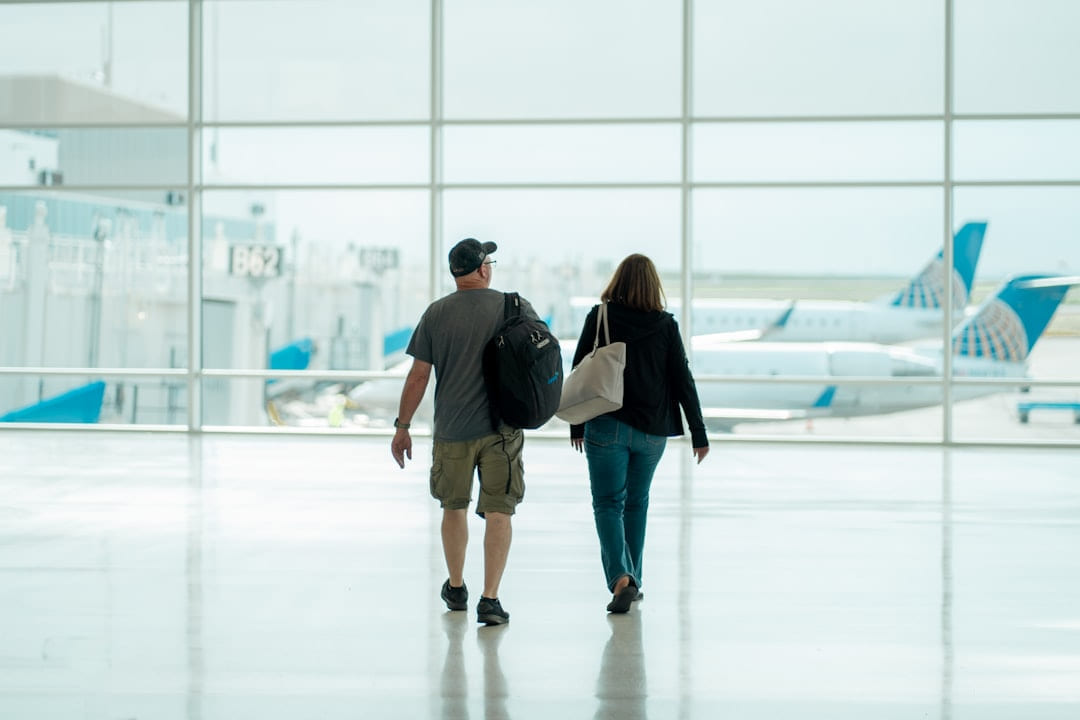a man and a woman walking through an airport on Miles and Memories