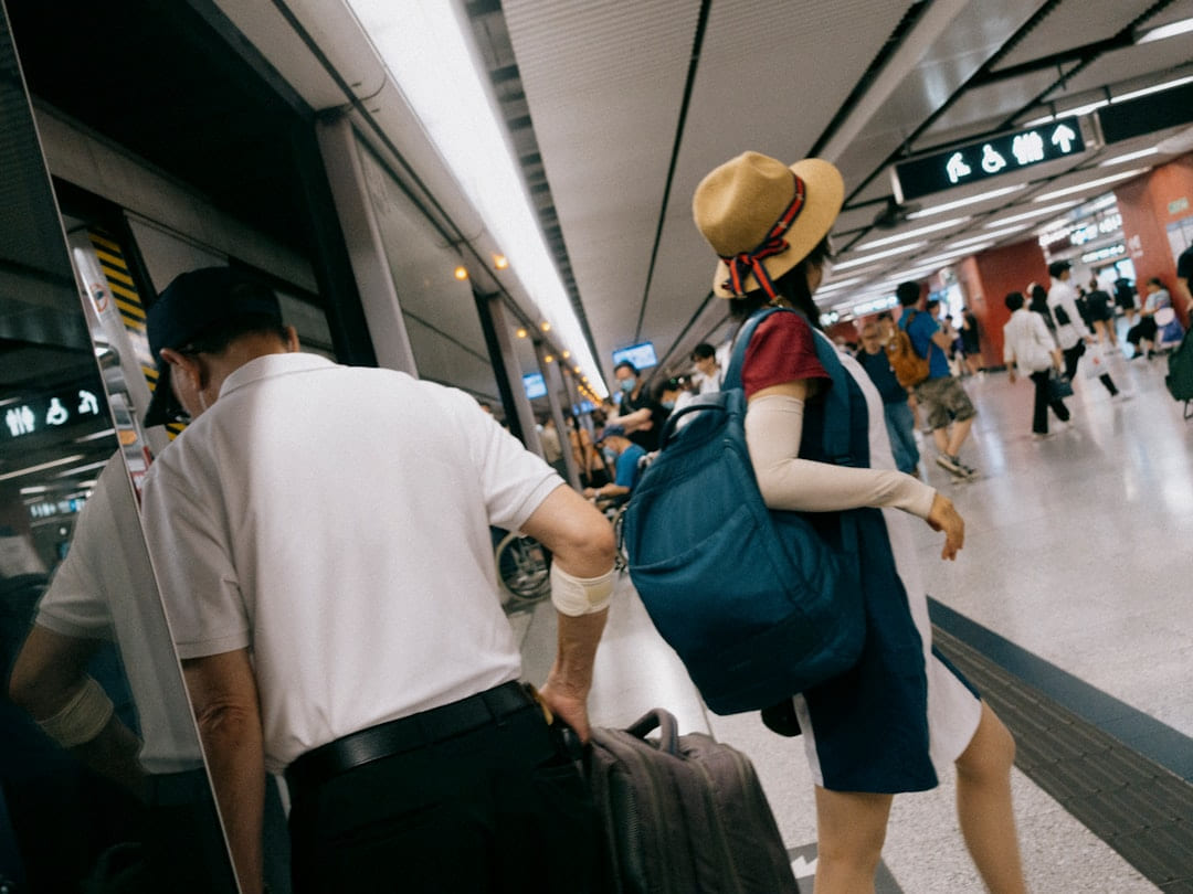 a man and a woman with luggage at an airport on Miles and Memories
